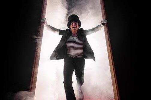 a man riding a snowboard down a snow covered slope