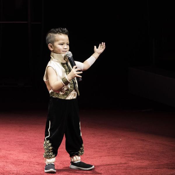a young boy standing in a dark room