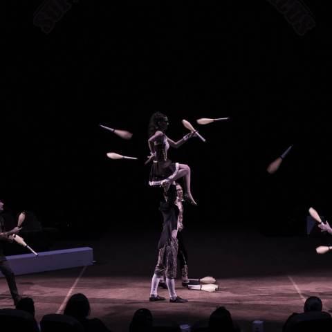 a group of people playing instruments and performing on a stage