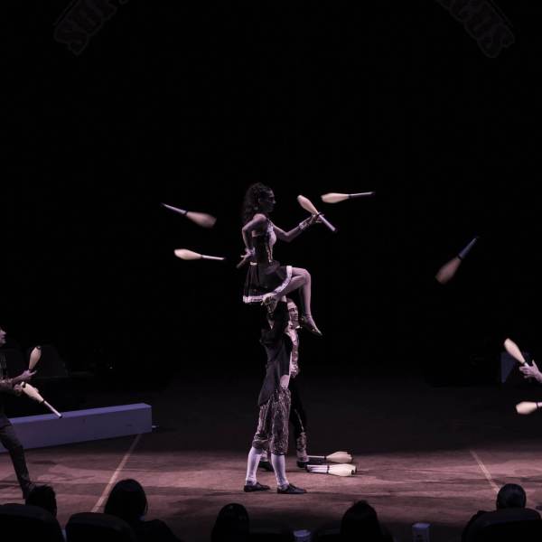 a group of people playing instruments and performing on a stage