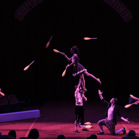 a group of people playing instruments and performing on a stage