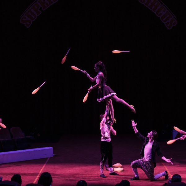 a group of people playing instruments and performing on a stage