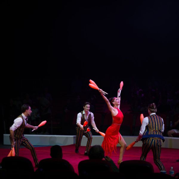 a group of people playing instruments and performing on a stage
