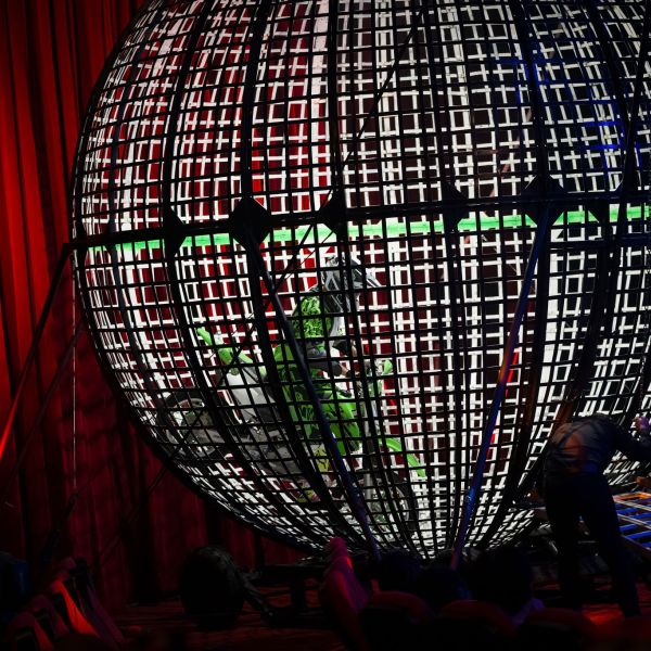 a person standing in front of a curtain