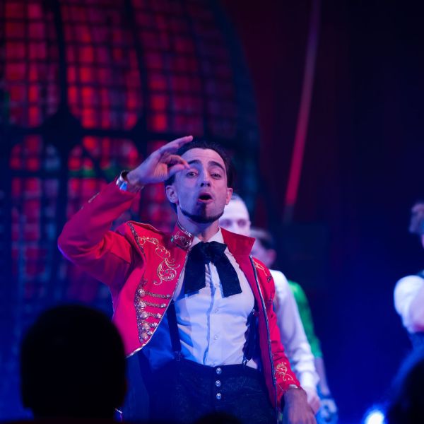 a man standing on a stage in front of a crowd